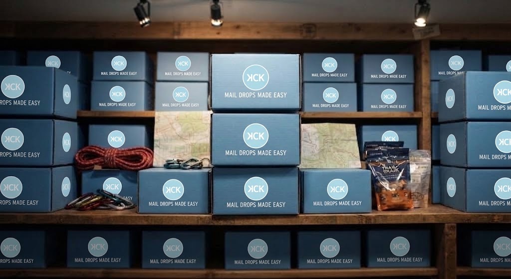A wall of packed KCK Mail Drops Made Easy boxes, ready to ship